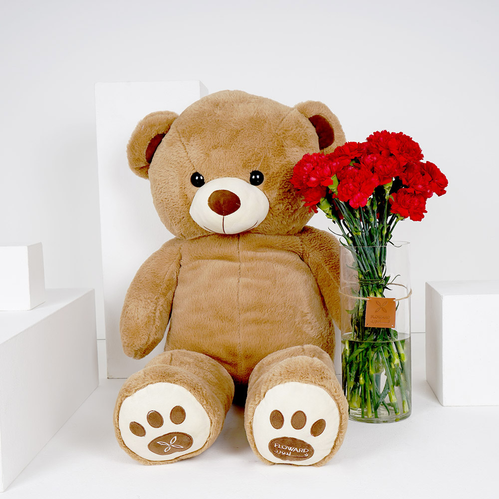 كرنيشن احمر مع فازة اسطوانية كبيرة و دمية دب كبيرة