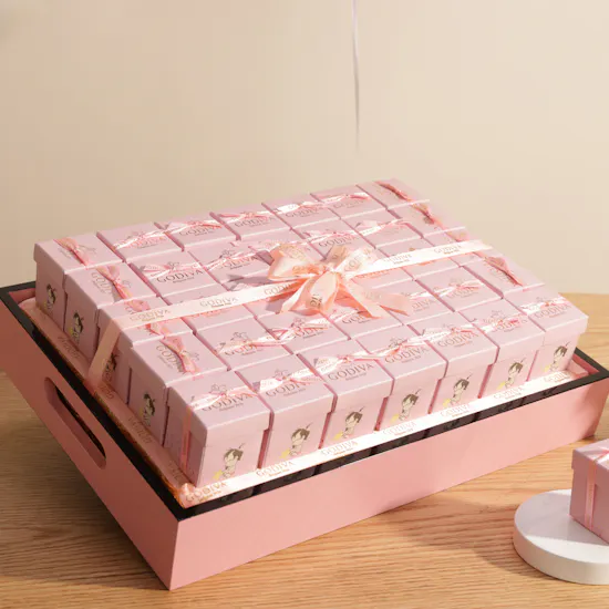 Godiva Baby Girl Chocolates with Flowers Beneath a Pink Cloud