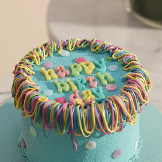 كيك يوم الميلاد بالوان قوس قزح من سويت أتيليه | مزهرية زهور دافئة
