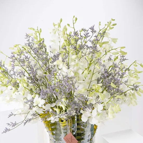 White Baby Orchids and Sea Lavender in a Yellow Vase